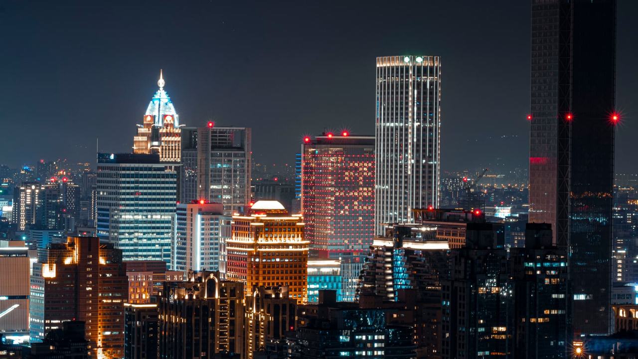 City skyline at night, seen from above.